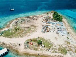 Dump island and ocean in Maldives. Ecological problem. Drone view photo