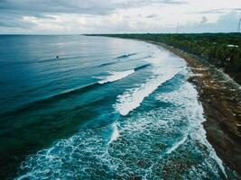 Aerial view of ocean with surf waves and coastline at Fuvahmulah island photo