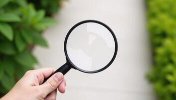 Hand checks for clean outdoor air using magnifying glass safe from pollutants dust PM 2 photo