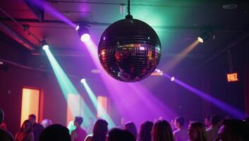 A vibrant disco ball illuminates a lively nightclub scene filled with dancing and colorful lights photo