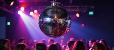Discothemed party scene with a reflective disco ball hanging from the ceiling photo
