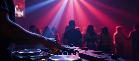 A DJ mixes tracks against pulsing strobe lights amidst a lively club setting photo