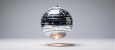 A discoball sphere glows brightly against a pristine white backdrop photo