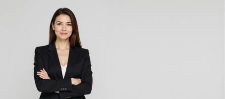 Businesswoman portrait against a clean white backdrop with crossed arms wearing professional attire photo