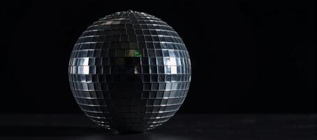 Isolated disco ball against black background photo