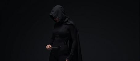 Mysterious hooded silent female rogue assassin photo