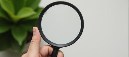 Hand checks for clean outdoor air using magnifying glass safe from pollutants dust PM 2 photo