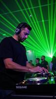 Illustration DJ playing music at a nightclub bathed in laser light show photo