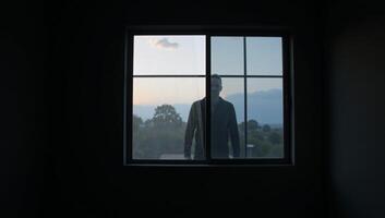 A dimly lit space featuring a large window photo