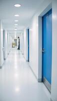 A clean sterile hospital corridor with blueandwhite doors depicted in a wide angle photo