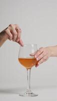 Vintage 60s70s styled image featuring an isolated hand holding a cocktail photo