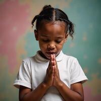 A closeup portrait of a young black girl praying surrounded by an abstract dreamy backdrop photo
