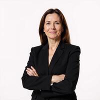 A professional businesswoman stands confidently against an isolating white backdrop dressed in a black suit with crossed arms photo