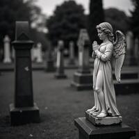 Gravestone with angel statue embodies grief remembrance wings signify prayer hope photo