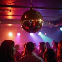 Retrostyle image featuring a shiny gold disco ball reflecting vibrantly at an energetic lively party photo