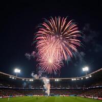 Vibrant firework display over a bustling football stadium photo