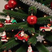 A vintagethemed Christmas tree adorned with classic Santas and old toy cars photo