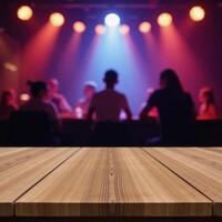 A blurred discoclub backdrop showcases an empty wooden table intended for product demonstrations photo
