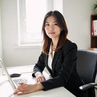 Businesswoman portrayed professionally in casual pose at her desk under natural window light in corporate setting photo