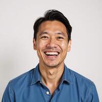 A Hawaiian man laughs uncontrollably at the camera against a simple white backdrop the background features an advertisement banner photo