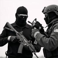 Armed terrorist with an AK47 faces off against masked special forces operative both armed and in combat attire photo