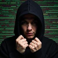 A hooded hacker amidst glitchy computer code glitch art photo