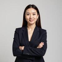 Businesswoman portrait featuring an isolated shot with crossed arms against a white backdrop photo