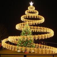 A goldengreen spiral of shimmering lights and particles forms a twirling Christmas tree with a dazzling glowing ladder at its base photo