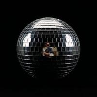 Isolated disco ball against black background photo