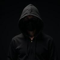 Computer Hacker Blackhooded figure in Dark Moody Background photo