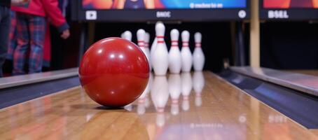 Cartoony image shows a bowling ball crushing pins in a bowling alley photo