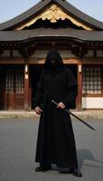 A solitary samurai stands guard outside a Japanese temple photo
