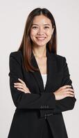 Isolated on white background A successful businesswoman smiles confidently with crossed arms and looks directly at the camera Positive Businessoriented photo
