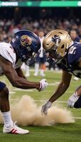 Football clash Two teams helmets collide on the gridiron symbolizing fierce competition in American football photo