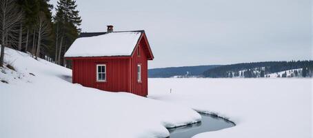 A winter wonderland scene featuring a cozy red cabin by a frozen lake evoking tranquility and escape photo