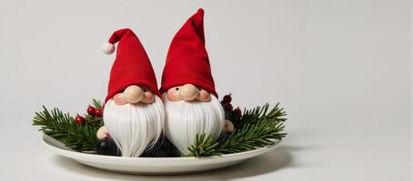 Festive Thanksgiving table features two Christmasthemed gnome figurines wearing red hats surrounded by pine and holly decorations photo