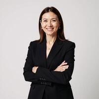 A professional confident businesswoman stands solo on a pristine white backdrop clad in black attire and striking pose photo