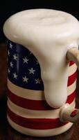 An Americanflagged beer mug overflowing with frothy head photo