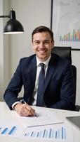 A contented financial analyst surrounded by growth charts photo