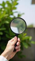 Hand checks for clean outdoor air using magnifying glass safe from pollutants dust PM 2 photo