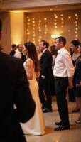 Party scene People in formal wear dancing against a blurred backdrop illuminated by golden lights and a bokeh effect photo
