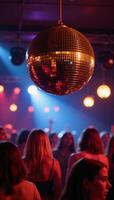 Retrostyle image featuring a shiny gold disco ball reflecting vibrantly at an energetic lively party photo