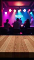 A blurred discoclub backdrop showcases an empty wooden table intended for product demonstrations photo