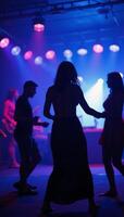 Dancing silhouettes in a lively colorful nightclub scene evoking the energy and exhilaration of a music event photo