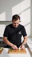 Man prepares food on a cutting board photo