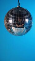 Vibrant blue backdrop with glittering disco ball for a lively party mood photo