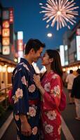 A romantic Japanese couple basks in fireworklit summer nights during a festive evening in Tokyo while dressed in traditional yukatas photo
