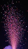 Multicolored nighttime festivity with flying confetti against a dark backdrop photo