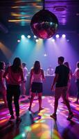 A vibrant disco ball illuminates a lively nightclub scene filled with dancing and colorful lights photo