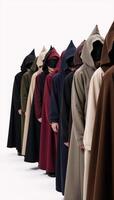 A line of robed figures with hoods gathers together photo